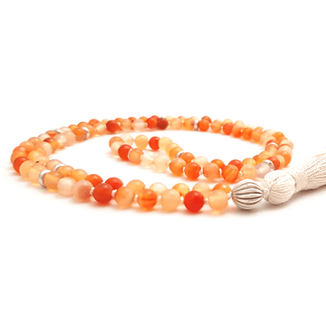 Handmade Sacral Chakra Mala Necklace – Carnelian for Passion & Creativity curled on table